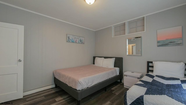 bedroom featuring crown molding and wood finished floors