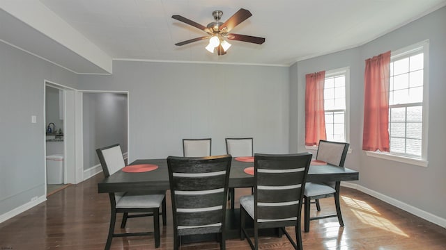 dining area featuring crown molding, wood finished floors, baseboards, and ceiling fan