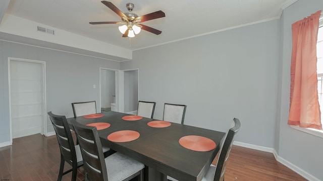 dining space with visible vents, ornamental molding, baseboards, and wood finished floors