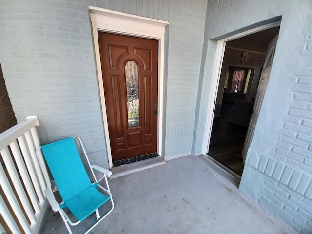 view of exterior entry with brick siding