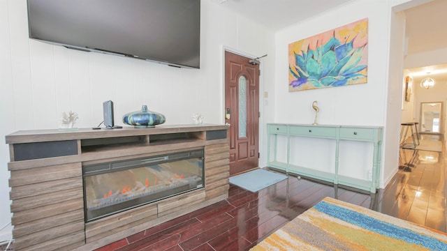 interior space featuring wood finished floors and a glass covered fireplace