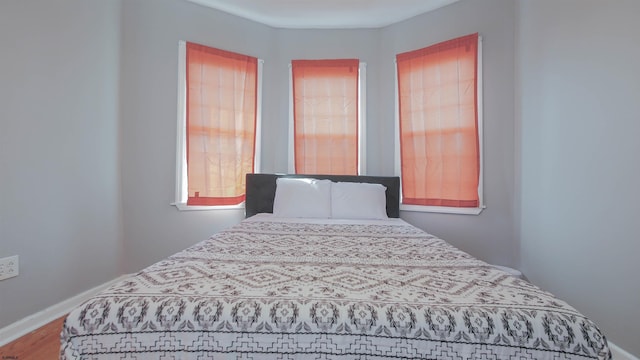 bedroom featuring wood finished floors and baseboards