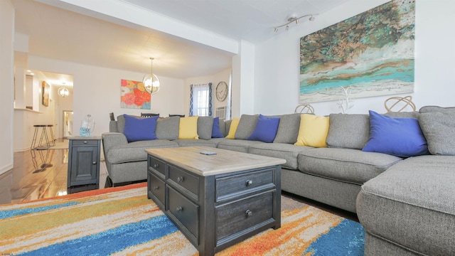 living room featuring track lighting and a chandelier