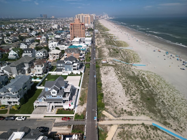 birds eye view of property featuring a beach view and a water view