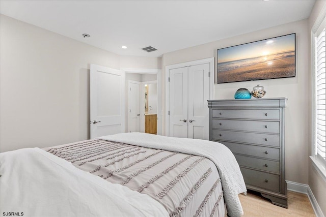 bedroom featuring visible vents, baseboards, multiple windows, and a closet