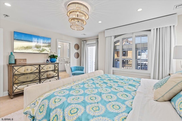 bedroom featuring an inviting chandelier, recessed lighting, wood finished floors, and visible vents