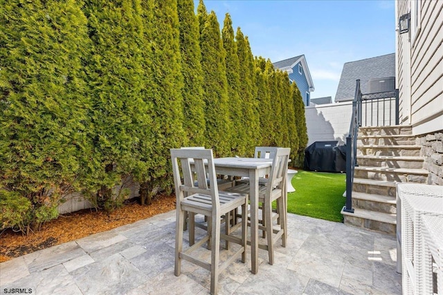 view of patio / terrace with outdoor dining area and a grill