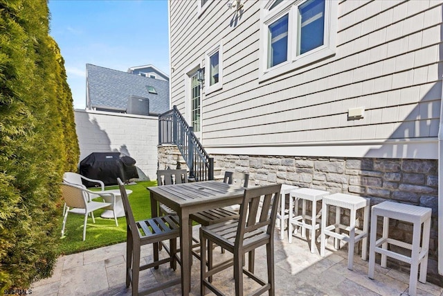 view of patio with area for grilling and outdoor dining space