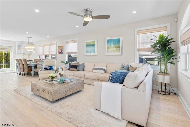 living area with recessed lighting, baseboards, and light wood-style floors