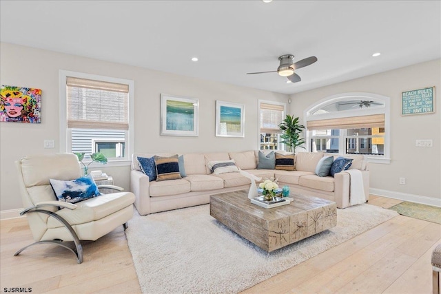 living area featuring baseboards, recessed lighting, a ceiling fan, and light wood-style floors