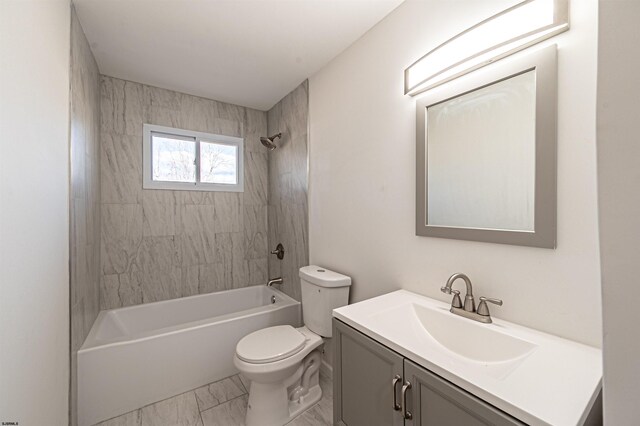 bathroom featuring vanity, toilet, tub / shower combination, and marble finish floor