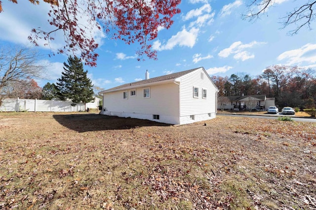 rear view of property with a yard and fence