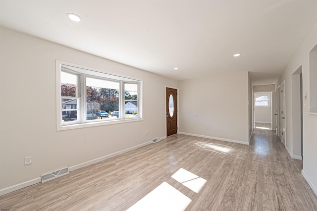 interior space featuring light wood-type flooring, visible vents, baseboards, and recessed lighting