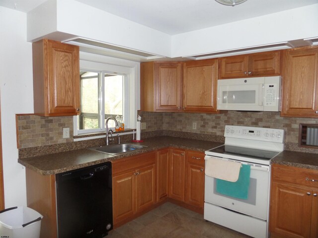 78 Tyler Rd, Greenfield, NJ 08230 - kitchen featuring white appliances, brown cabinetry, a sink, dark countertops, and backsplash