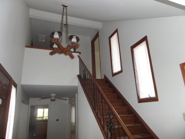 78 Tyler Rd, Greenfield, NJ 08230 - staircase with ceiling fan with notable chandelier, a towering ceiling, and a baseboard radiator