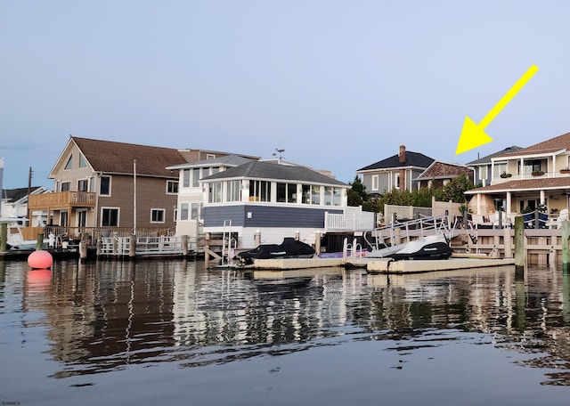 dock area with a residential view and a water view