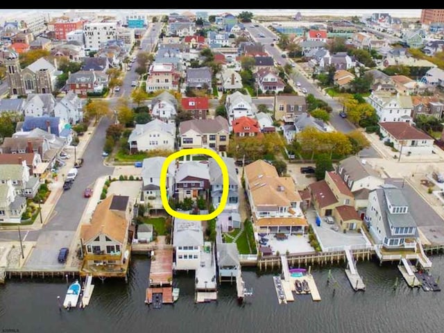 drone / aerial view featuring a residential view and a water view