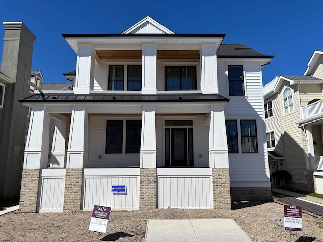 view of front of house featuring a balcony, a porch, a standing seam roof, and board and batten siding