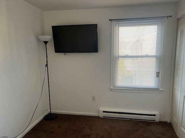 interior space with baseboards, carpet, and a baseboard radiator