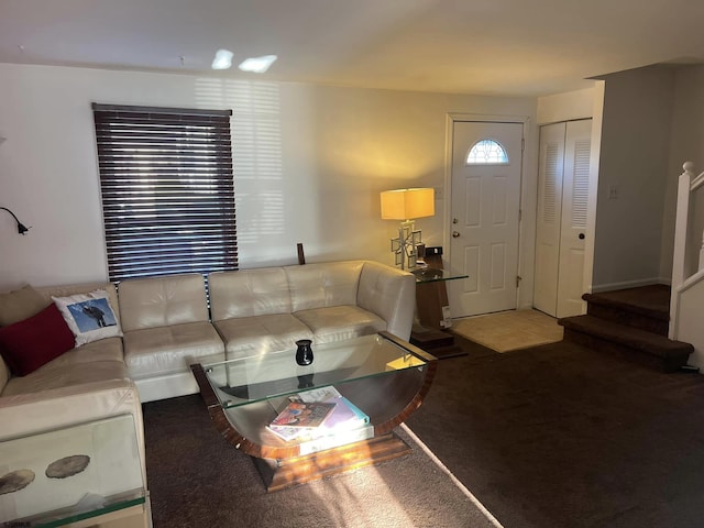 carpeted living area featuring stairway