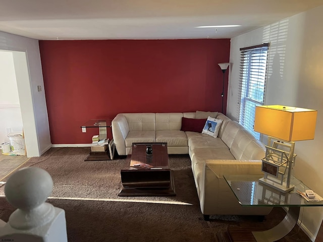 carpeted living area featuring baseboards