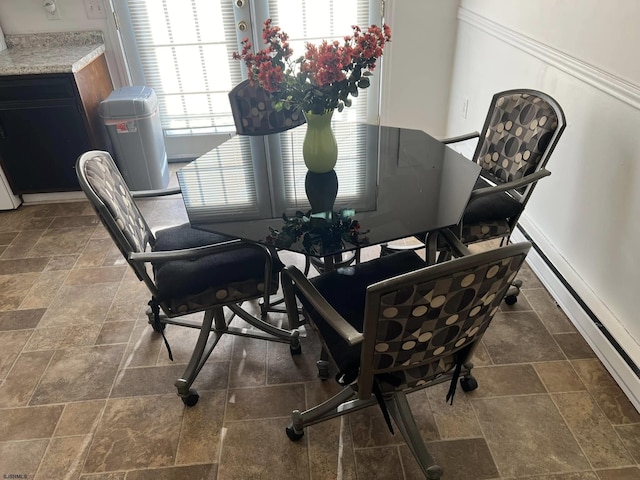 dining room featuring baseboards and stone finish flooring