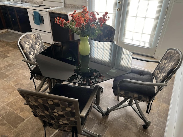 dining area featuring stone finish flooring