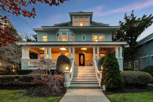 traditional style home with stairway and covered porch