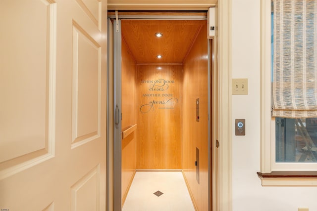 interior details featuring elevator and recessed lighting