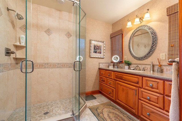 full bath featuring tile patterned floors, a stall shower, and vanity