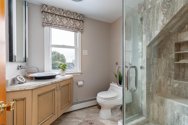 bathroom featuring vanity, a shower stall, toilet, and baseboard heating