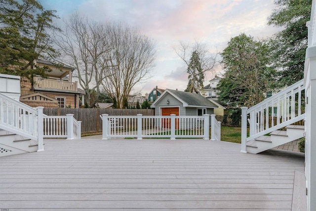 wooden deck featuring an outdoor structure and fence