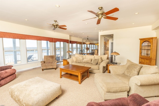 living room with recessed lighting, baseboards, light carpet, and a ceiling fan