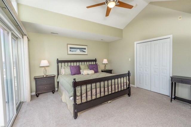 carpeted bedroom with visible vents, baseboards, a closet, high vaulted ceiling, and a ceiling fan