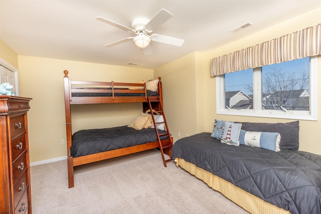 bedroom with baseboards, carpet flooring, a ceiling fan, and visible vents