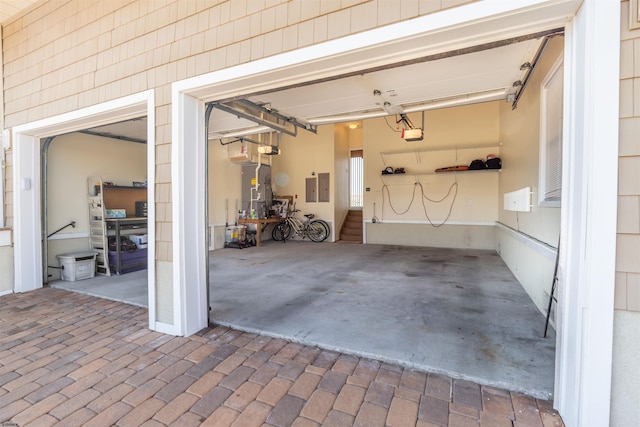 garage with electric panel and a garage door opener