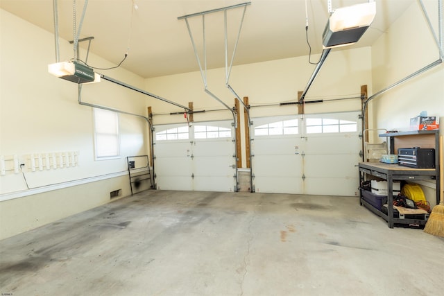 garage with visible vents and a garage door opener