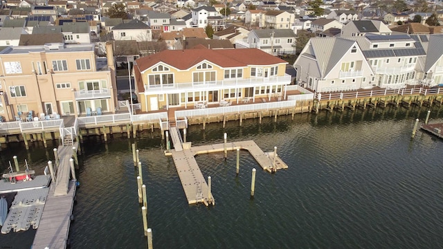 birds eye view of property featuring a residential view and a water view