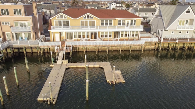 dock area with a residential view and a water view