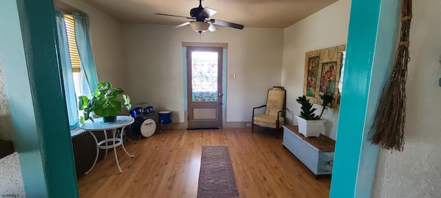 foyer with a ceiling fan, light wood-type flooring, and baseboards