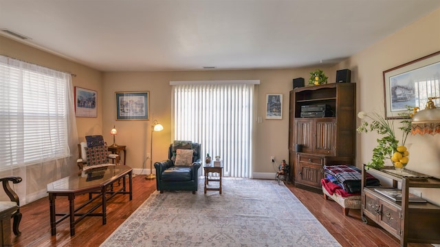 sitting room featuring visible vents, baseboards, and wood finished floors