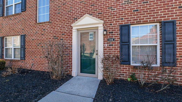 entrance to property with brick siding