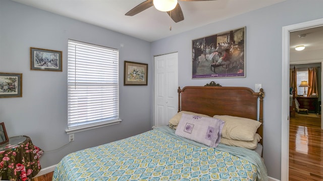 bedroom featuring a closet, baseboards, and a ceiling fan