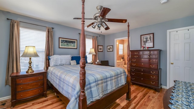 bedroom featuring connected bathroom, baseboards, a ceiling fan, and light wood finished floors