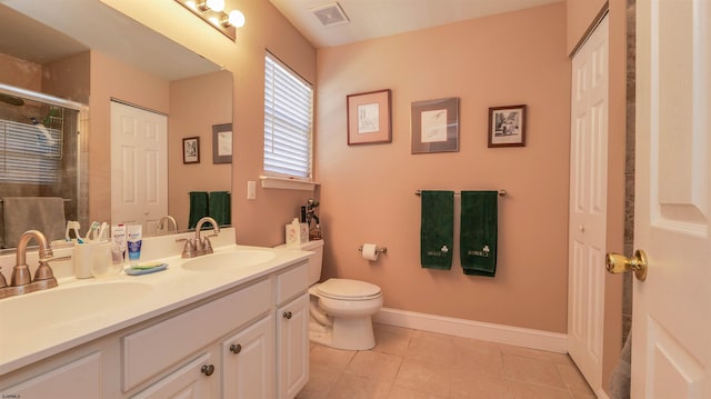 full bath featuring double vanity, visible vents, a stall shower, and a sink