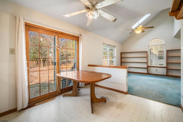 dining room featuring tile patterned floors, baseboards, and lofted ceiling