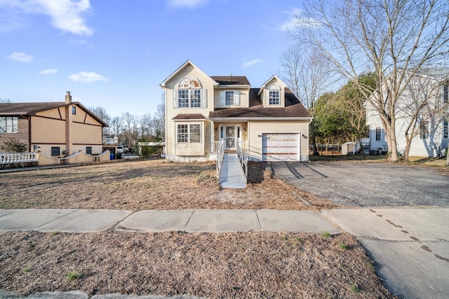 view of front of home featuring roof mounted solar panels, fence, a garage, and driveway