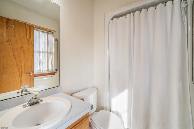 bathroom featuring vanity, toilet, and a shower with curtain