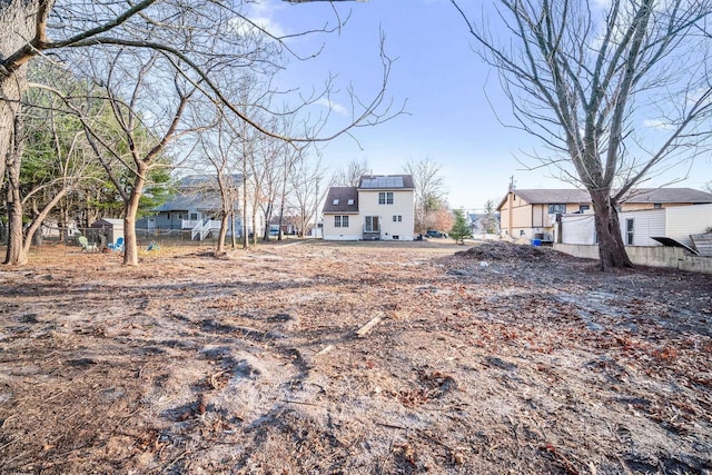 view of yard featuring a residential view and fence