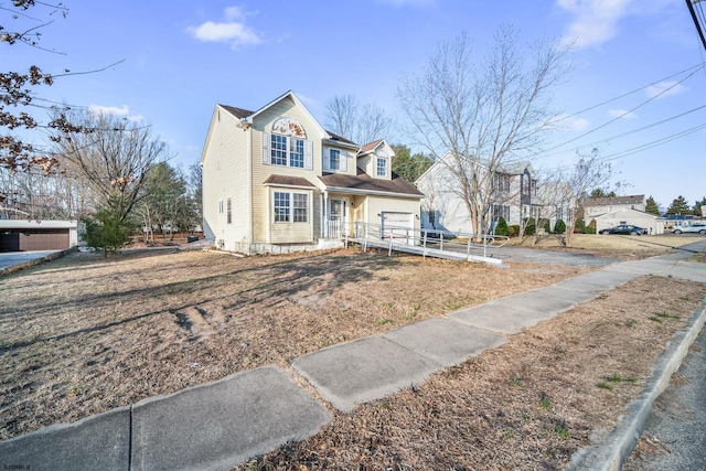 view of front facade featuring driveway and fence